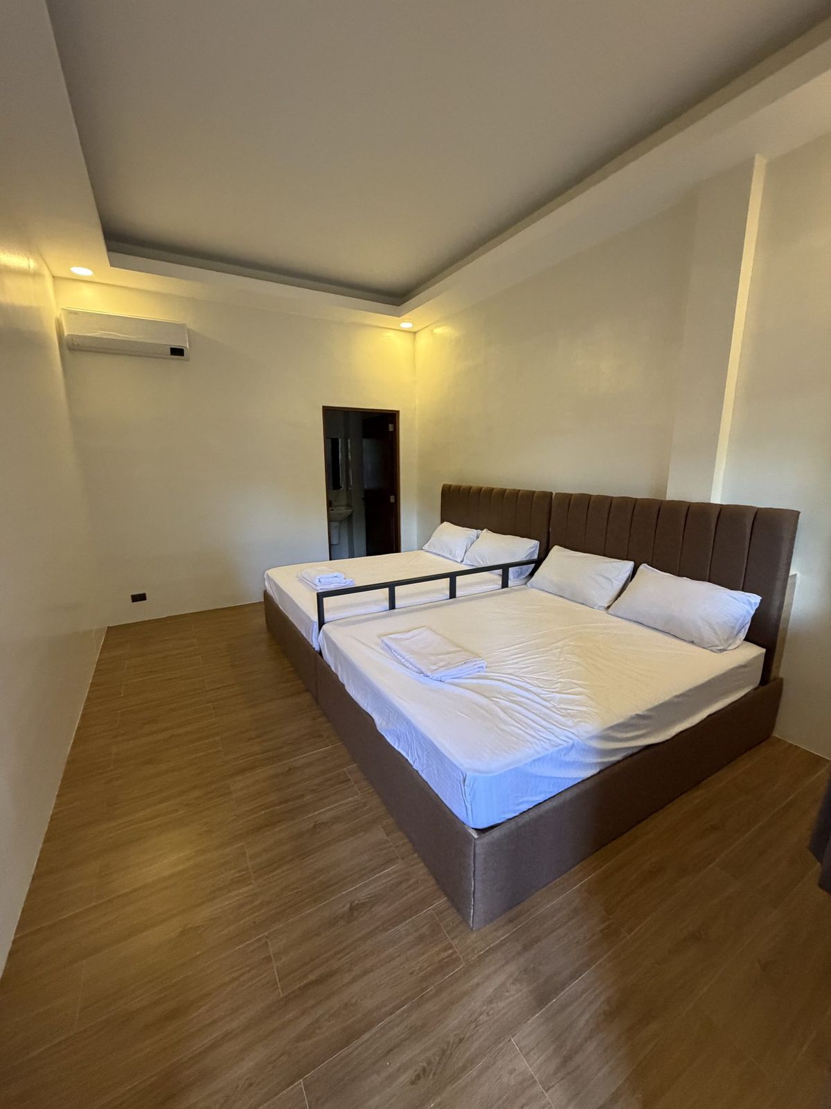 A third double room in cooler daylight, plainly furnished