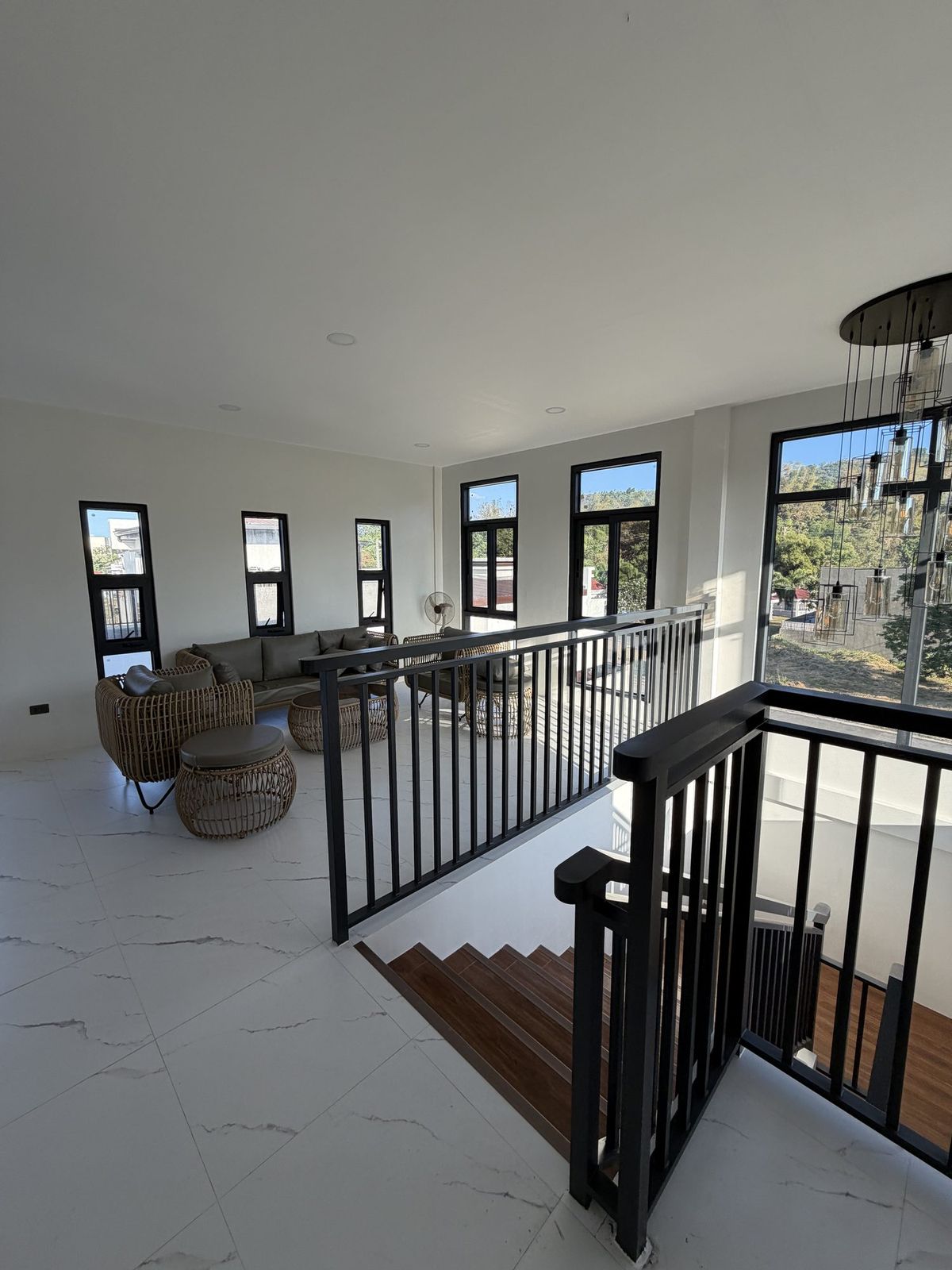 The upper living area, wide and open, with seating along the windows